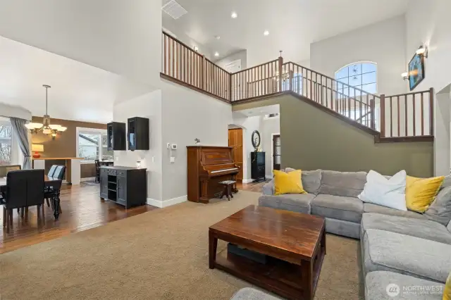 Looking across the living room toward the entryway. The formal dining area is to the left and there is an informal dining area beyond that off the kitchen.