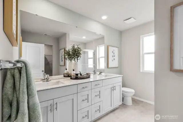 Primary ensuite bath with double sink vanity and shower. Pictures are representative of Burnham floorplan. Colors and options will vary. Photos from Model Home on 30. Homesite 77 is a mirror image.