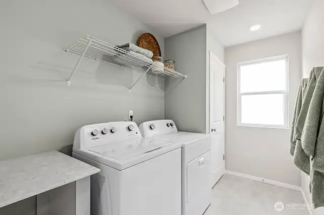 Great utility room located on upper level. Handy closet and counter for folding.  Colors and options will vary. Photos from Model Home on 30. Homesite 77 is a mirror image.