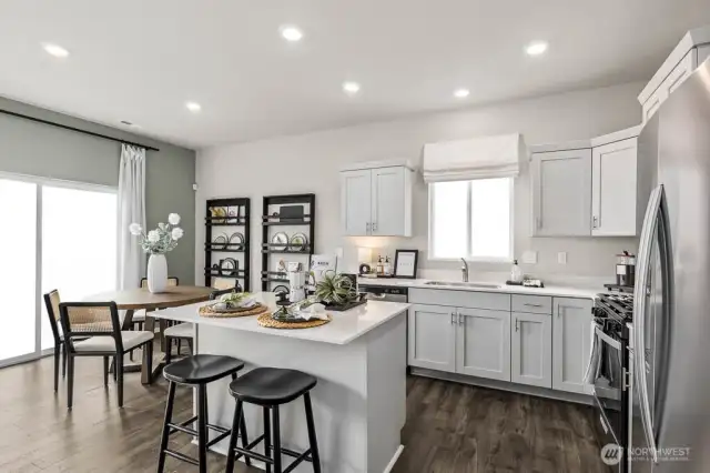 Beautiful kitchen with island and dining space. Pictures are representative of Burnham floorplan. Colors and options will vary. Photos from Model Home on 30. Homesite 77 is a mirror image.