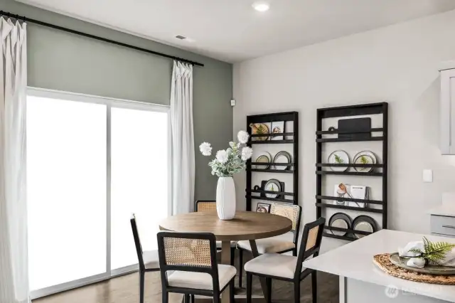 Dining space with bright slider that opens onto patio. Pictures are representative of Burnham floorplan. Colors and options will vary. Photos from Model Home on 30. Homesite 77 is a mirror image.