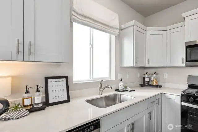 Window over kitchen sink opens to enjoy outside air. Pictures are representative of Burnham floorplan. Colors and options will vary. Photos from Model Home on 30. Homesite 77 is a mirror image.