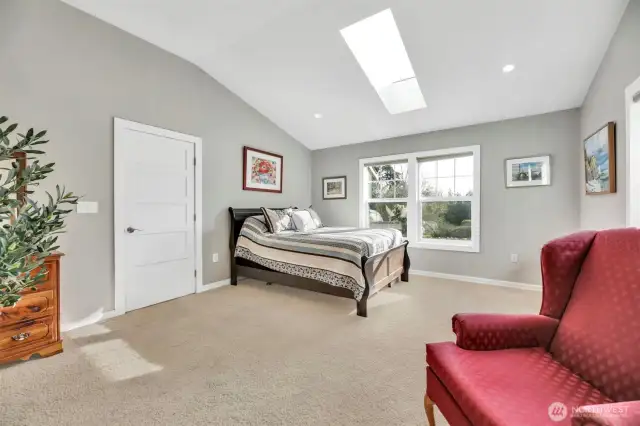 Main primary ensuite with a gas fireplace and walk in closet.