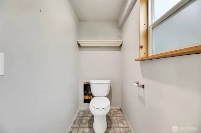 Half Bath in Shop.  Sink is on the other side of the wall, separated by a sliding door.