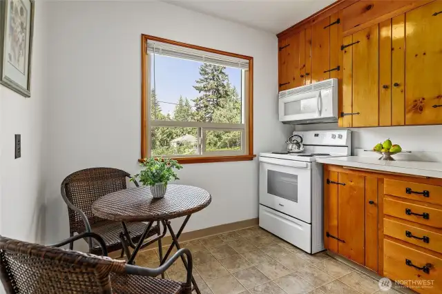 Beautiful warm wood cabinets grace the eat-in kitchen