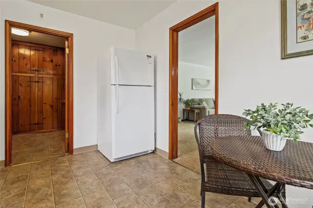 Left of the new fridge is the entry from the good-sized utility room.
