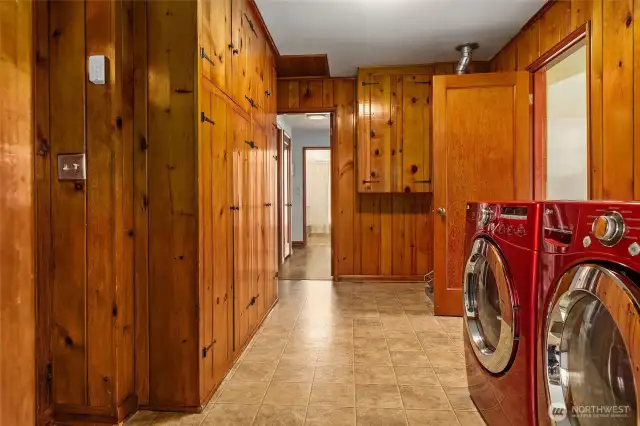 water heater behind door into kitchen, wall of cabinets on left currently function as a pantry. Washer and Dryer stay, too.