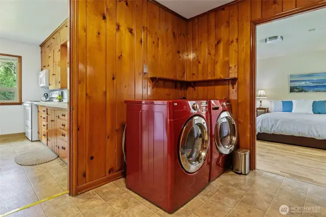 Looking back on kitchen and into serene primary bedroom. Laundry is so conveniently situated.