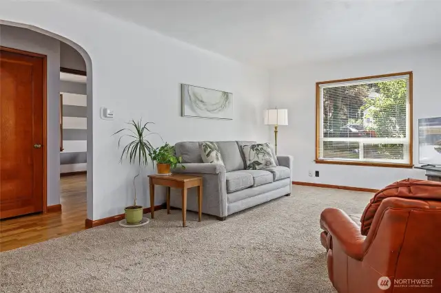 Coved ceilings, and archway into hall from spacious, light, bright living room