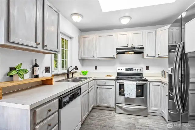 The kitchen has plenty of counter space for prepping meals and cooking.