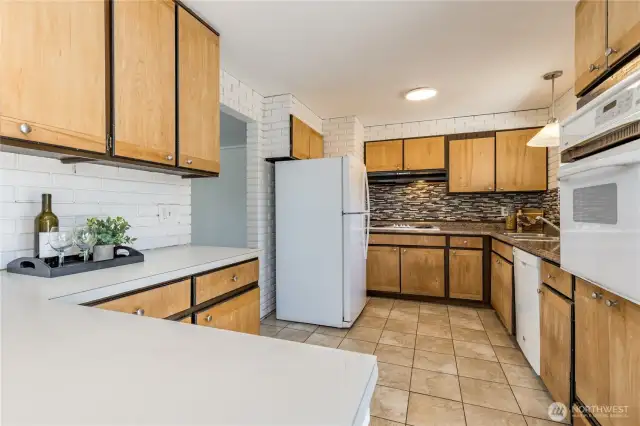 Charming brick walls, tiled floor and great storage here