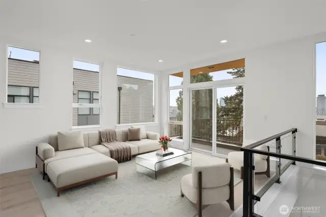 This photo is virtually staged.   Cozy up in the spacious living area with private deck! This image is virtually staged.