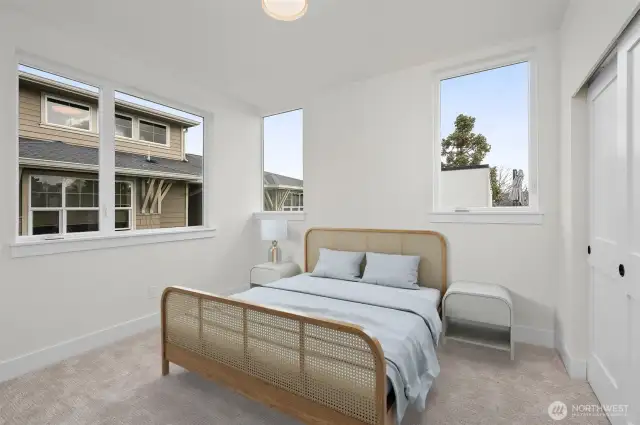The third level bedroom can be used as a primary suite expansion, or additional guest bedroom! This image is virtually staged.