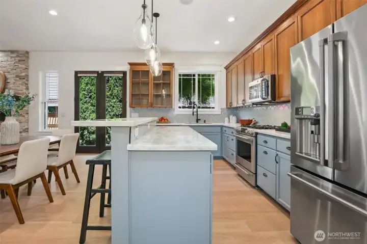 Recently remodeled kitchen follows all the current trends with high-end stainless steel appliances & big breakfast bar.