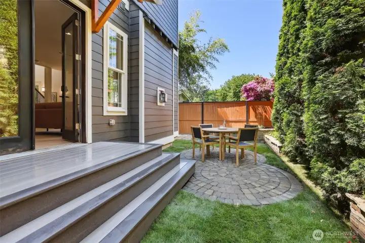 Backyard space has a patio for dining, garden beds, and room for a playset if desired.