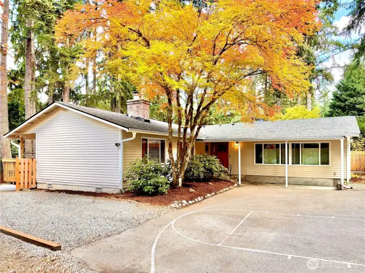 Welcoming front entry framed by lush greenery
