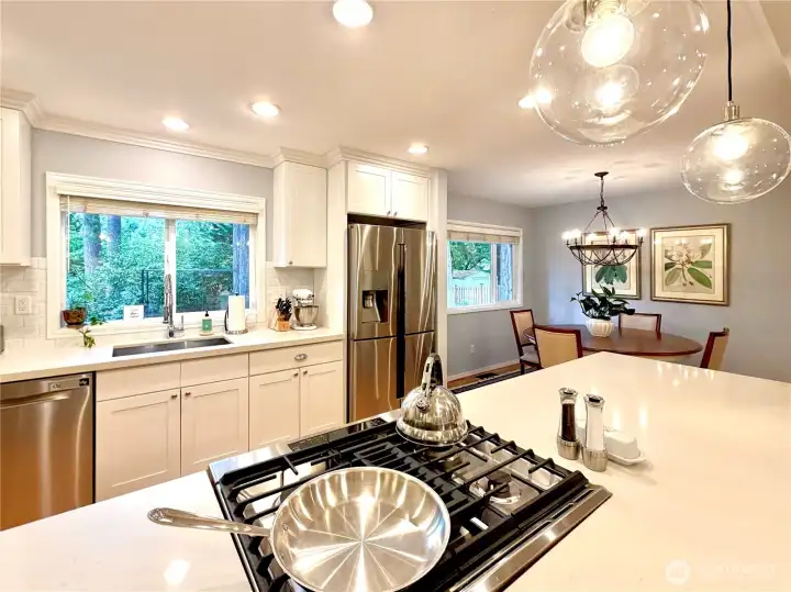 Sleek kitchen with quartz counters and stainless appliances