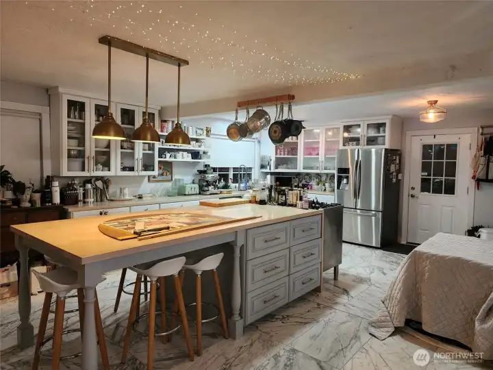 Spacious kitchen, huge island, custom range and two wine fridges