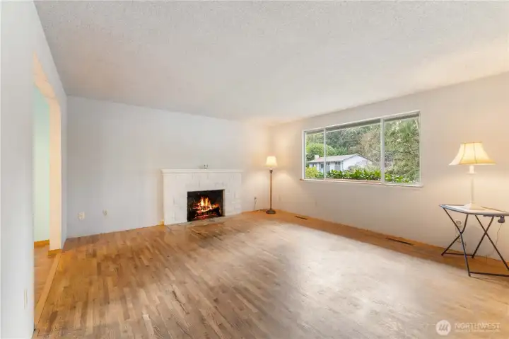 Spacious living room featuring inviting fire place.