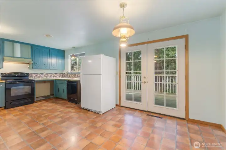 Kitchen with eating space and French doors that open to the deck.