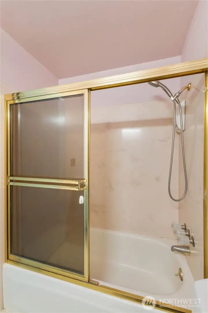 Bathtub/shower in main bathroom.