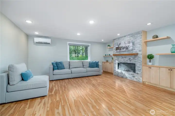 Gorgeous open concept LR with custom shelving and fireplace