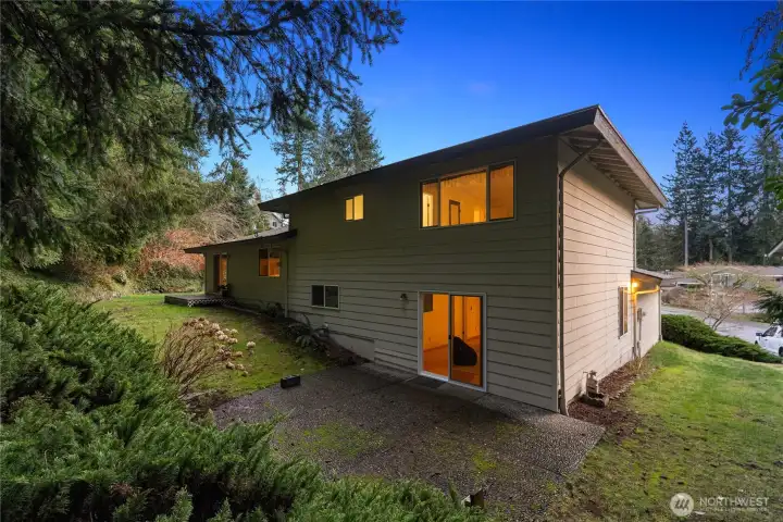 Spacious backyard setting with patio access, offering endless potential to create your ideal outdoor retreat.