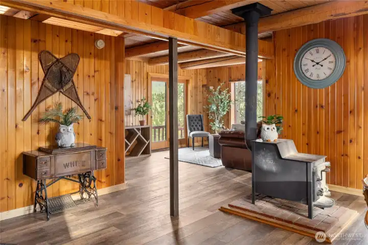 At the center of the home, a wood-burning stove offers both efficient heat and timeless cabin character.