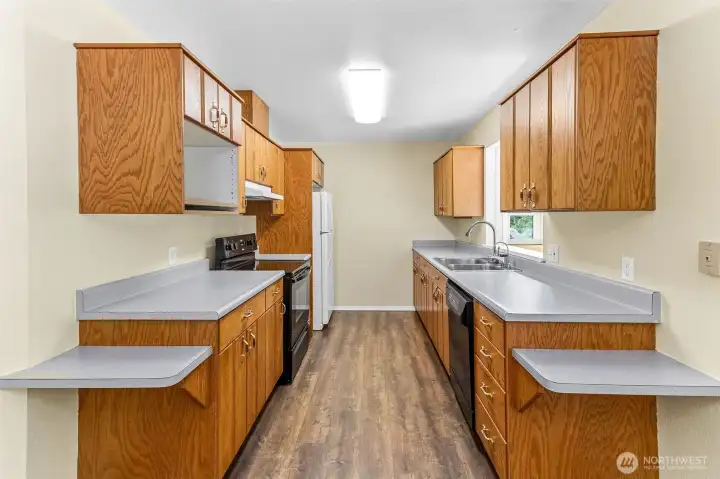 Galley style kitchen with plenty of storage and eating bars on either side