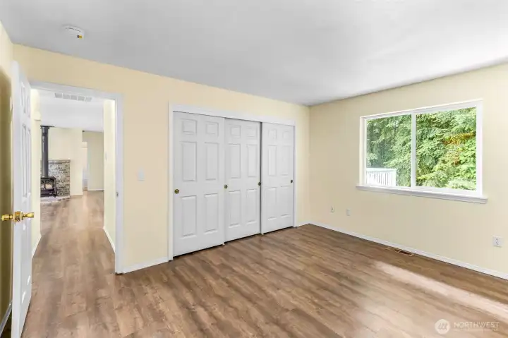 Primary bedroom looking down hallway to living room