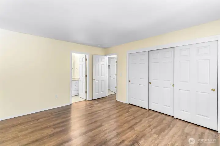 Primary bedroom with large three door closet and on-suite full bath