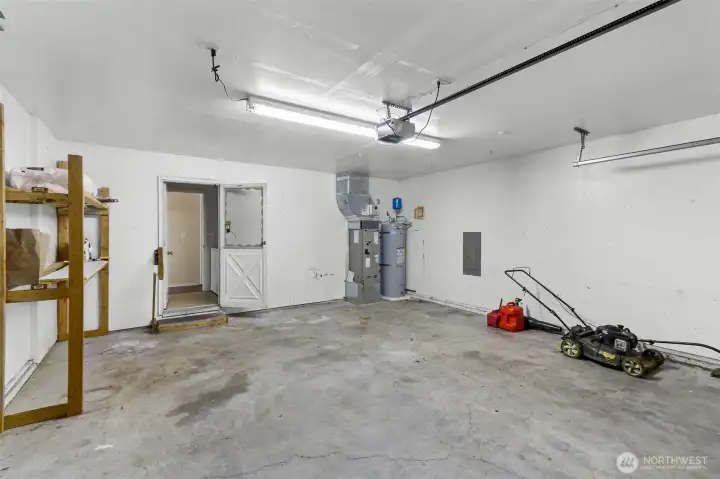 Large 2 car garage with storage shelves that can convey with home!
