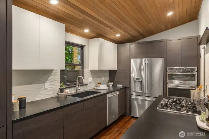 European soft-close cabinetry, honed granite countertops and all stainless steel appliances are the highlights of this Chef's kitchen. A handy door leads you to your large front porch from the kitchen too.