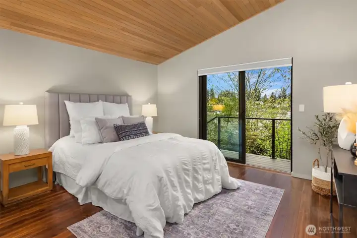 Moving over to the primary bedroom on the other side of the home. Terrific water views from this bedroom. Easy access out to the deck and hot tub from this room.
