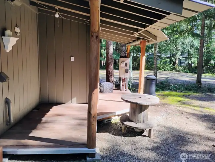 Extra covered area on back of outbuilding makes a great porch for RV guests!