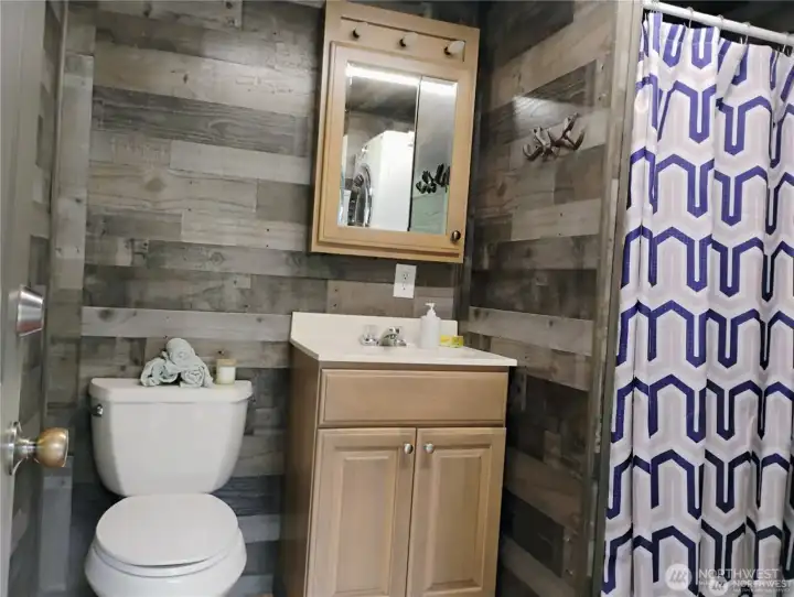 convenient bathroom with a shower and laundry room