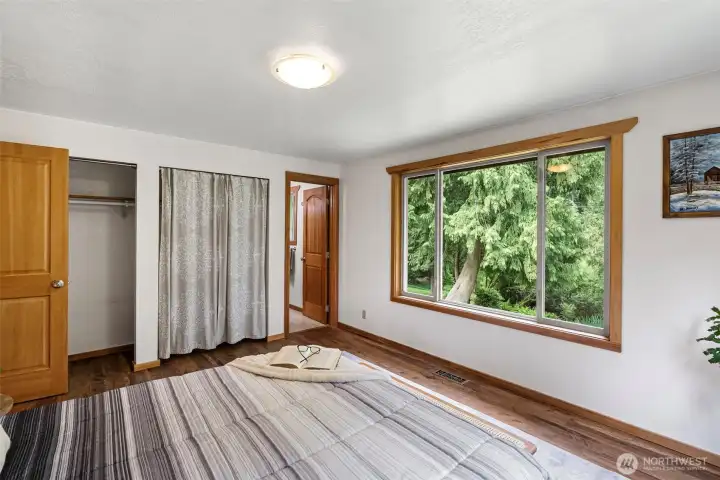 primary bedroom overlooks forest and pond