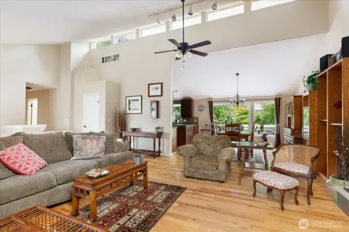 living room with gas fireplace, dining area, and kitchen with abundant cabinetry. living room with gas fireplace, dining area, and kitchen with abundant cabinetry.