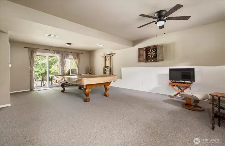 Large lower-level rec room with direct access to the backyard, offering flexible space for gatherings, hobbies, or a home office. Large lower-level rec room with direct access to the backyard, offering flexible space for gatherings, hobbies, or a home office.