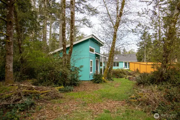 Expansive second lot with mature deciduous trees and a storage shed — part of the property's double lot. Expansive second lot with mature deciduous trees and a storage shed — part of the property's double lot.