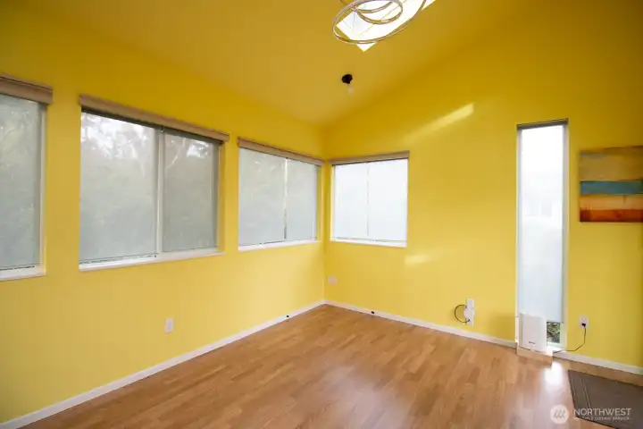 Open, light-filled studio with windows on all walls and a vaulted ceiling. Open, light-filled studio with windows on all walls and a vaulted ceiling.