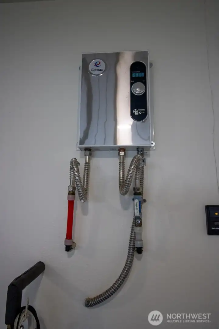 Energy-efficient electric tankless water heater providing on-demand hot water. Energy-efficient electric tankless water heater providing on-demand hot water.