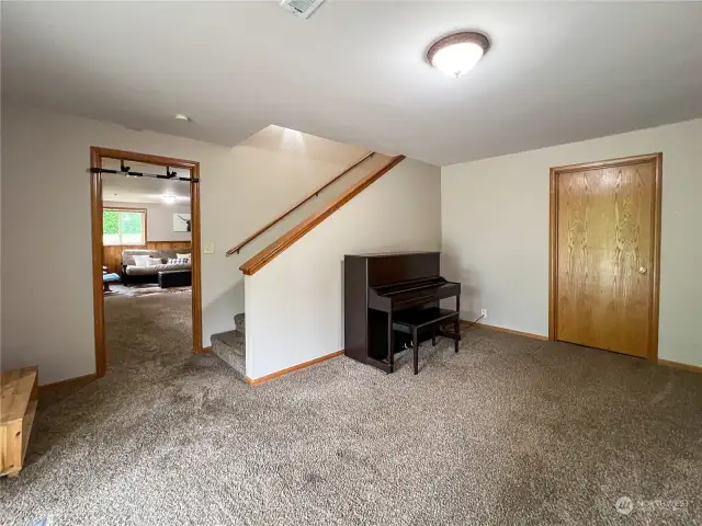 Lower level stairs and landing with room for office area. There is a great unfinished storage area as well.