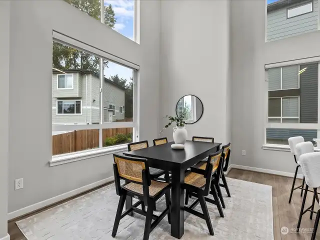 Dining area is surrounded by windows with custom blinds, bringing in all the natural light.