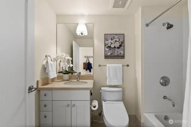 Unwind in the cozy shower-tub combo, ideal for enjoying a warm bubble bath on cold winter nights. Additionally, the bathroom features a Japanese Washlet bidet for enhanced comfort.