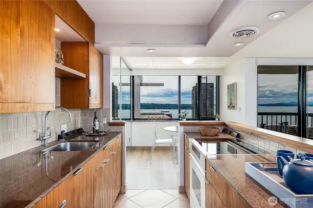 Custom walnut cabinetry, art nook above sink,   drawer dishwasher.