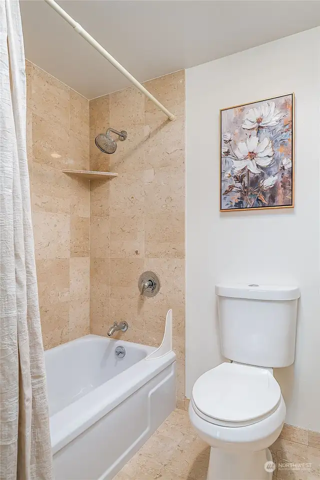Bathtub/shower with    tile surround and toilet separate from vanity