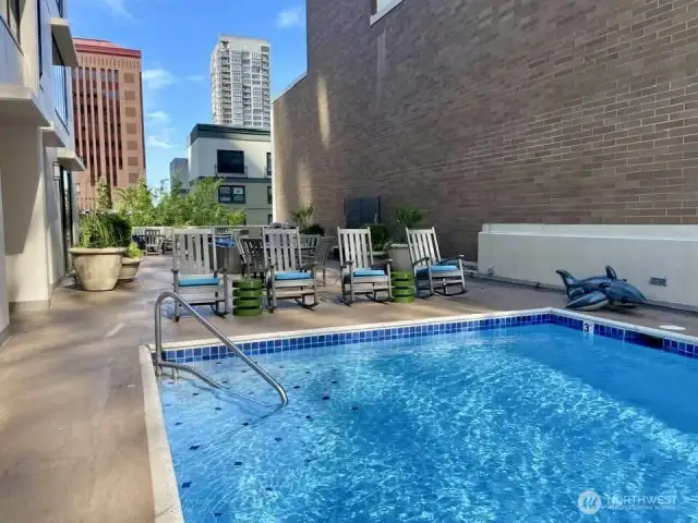 Outdoor heated pool on 4th floor with new deck chairs.