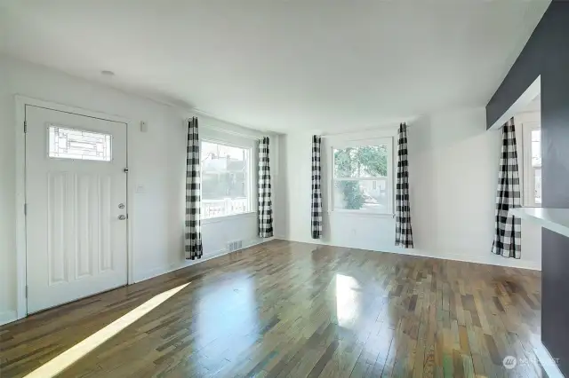 Open concept living space with large windows.