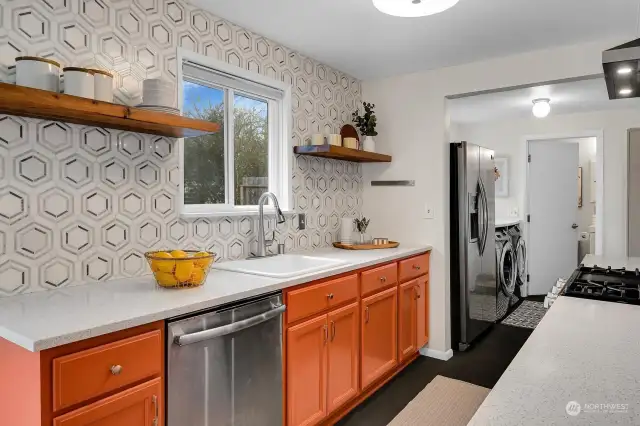 Cultured stone countertops and a snazzy backsplash complete this modern refresh of the kitchen.